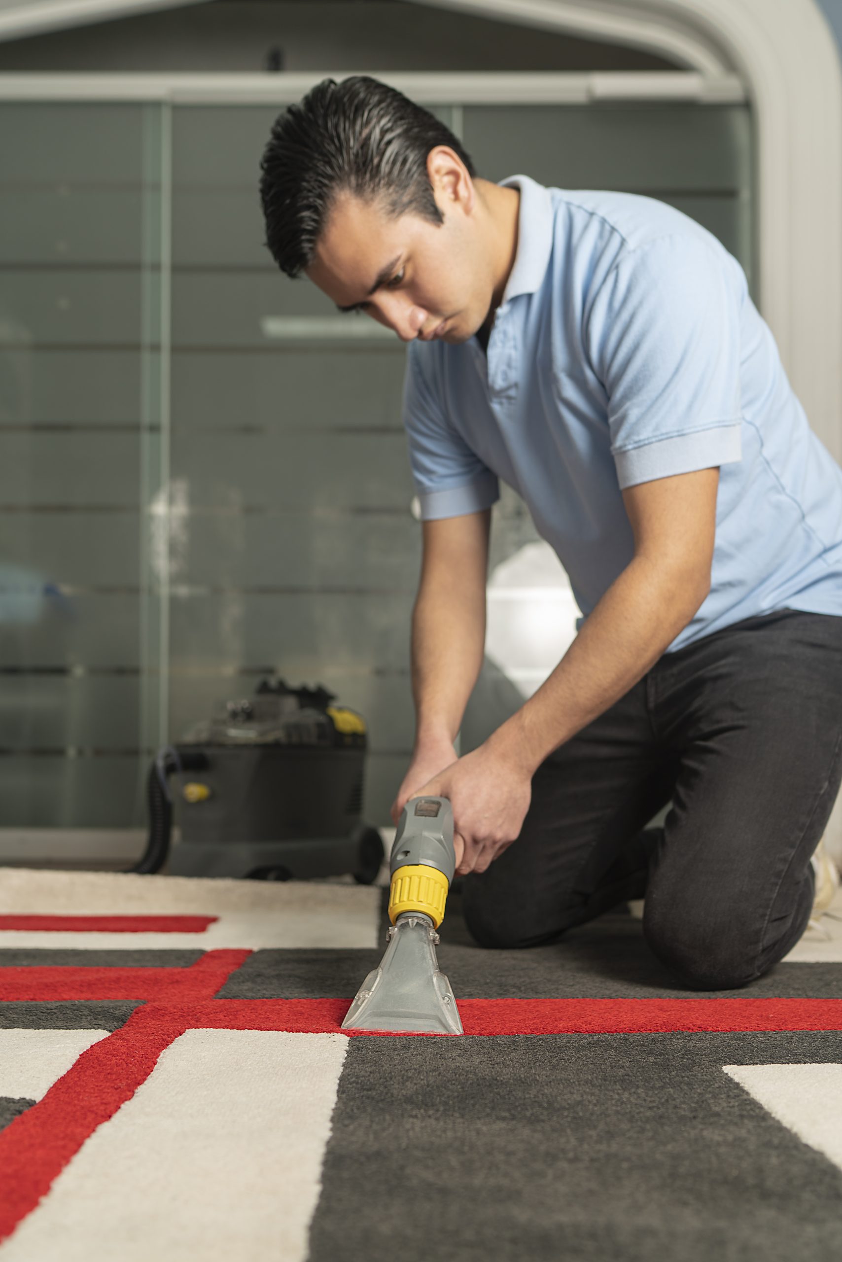 Person cleaning carpet with a special equipment