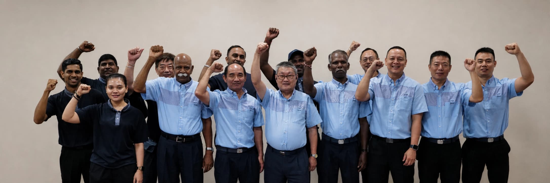 The Crusade Services team with arms raised, photographed in Singapore