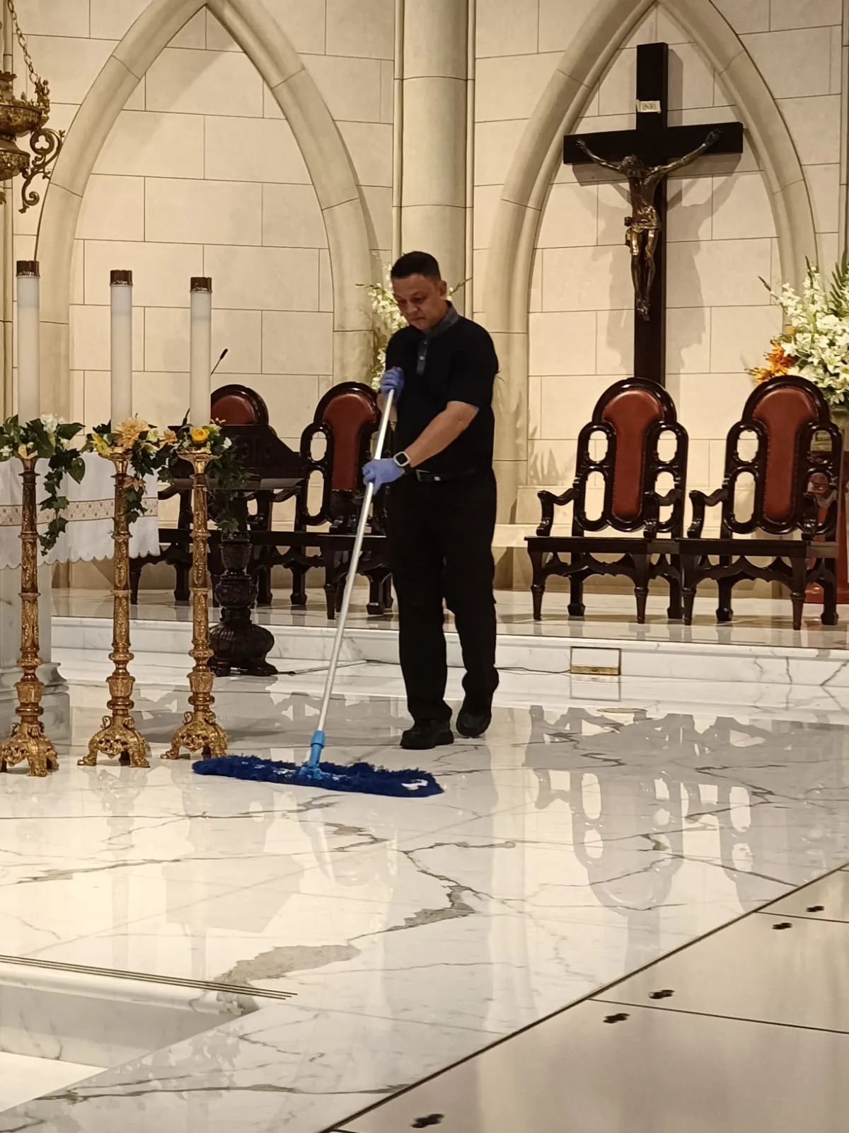 A Crusade technician mopping a church's marble floor