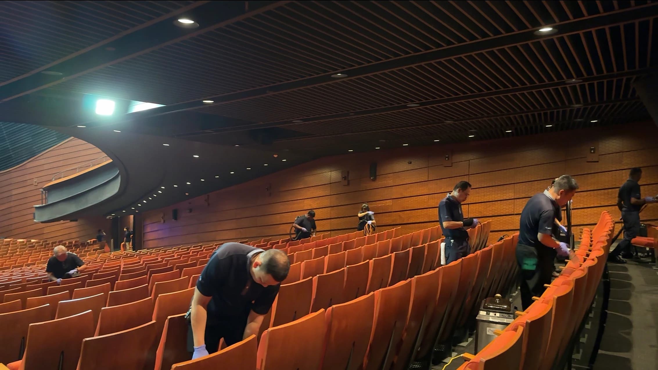 The Crusade crew cleaning a full auditorium of seating