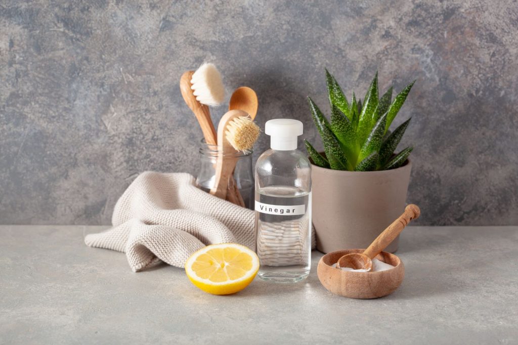 picture of brushes and bottle of soap with lemon for cleaning