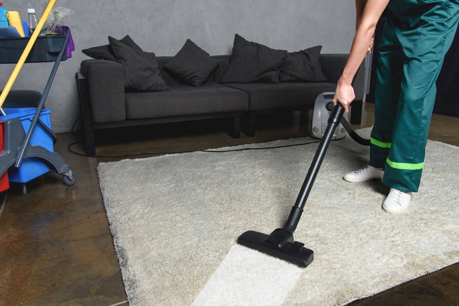 a person is cleaning the dirty rug
